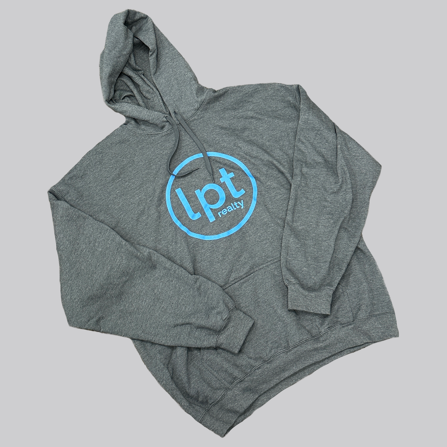 A heather gray hoodie with a subtle sheen and a large, light blue “lpt realty” circle logo silkscreened onto the center chest.