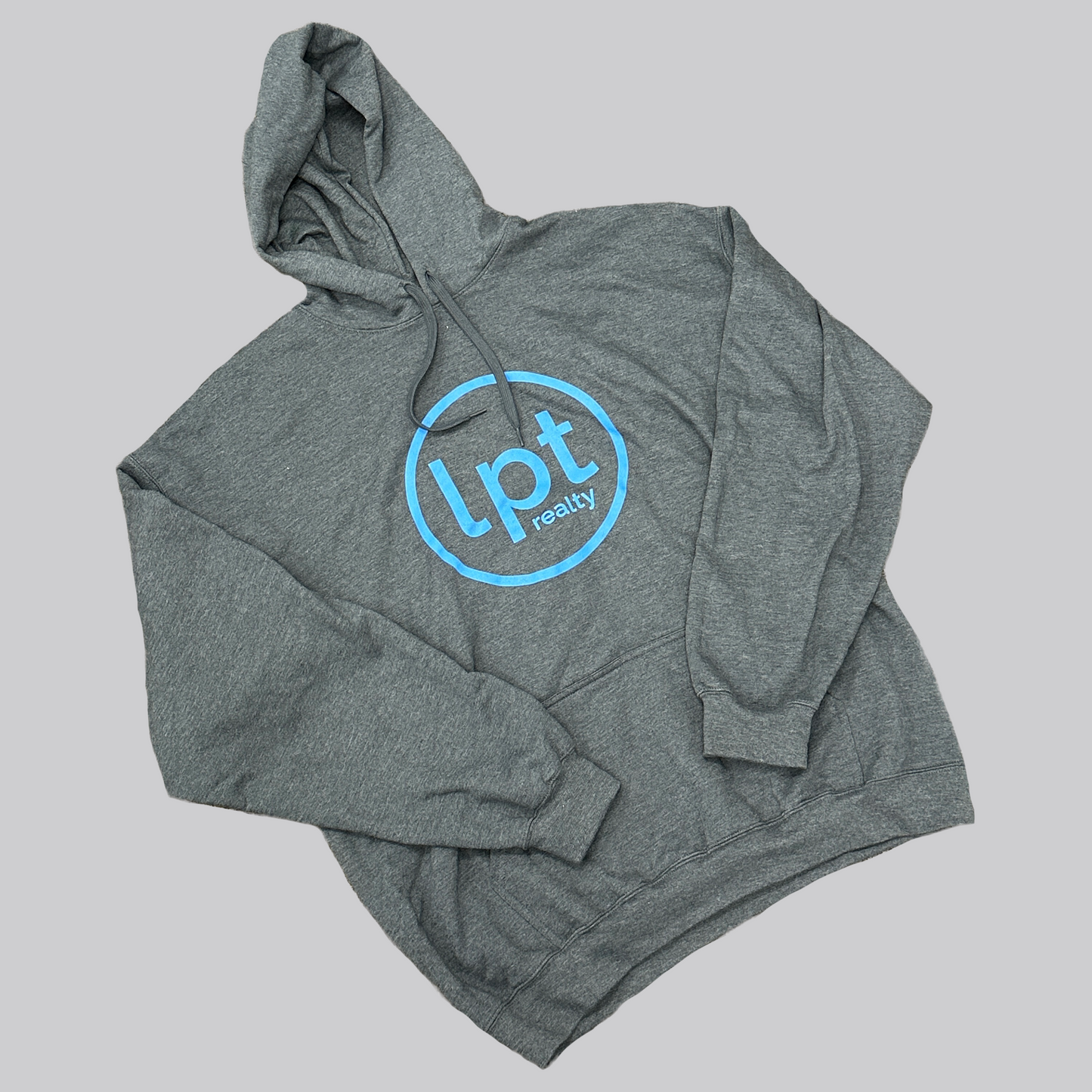 A heather gray hoodie with a subtle sheen and a large, light blue “lpt realty” circle logo silkscreened onto the center chest. 