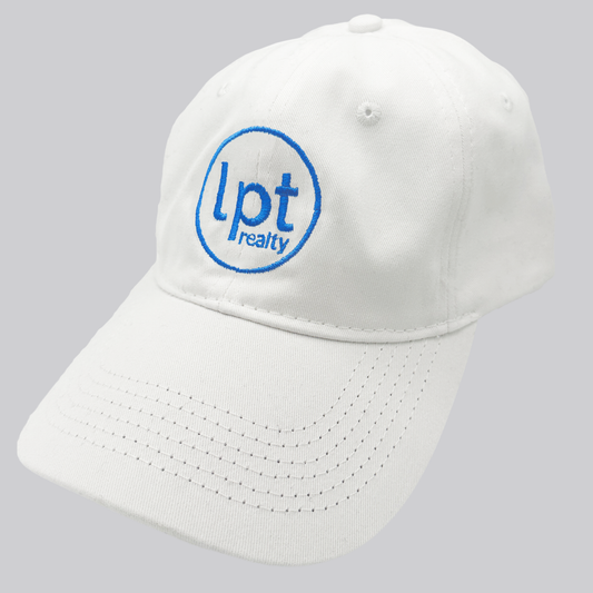 A white twill cap with a relaxed fit, matching stitching, and embroidered eyelets. The front panels feature the “lpt realty” circle logo embroidered in bright blue. 