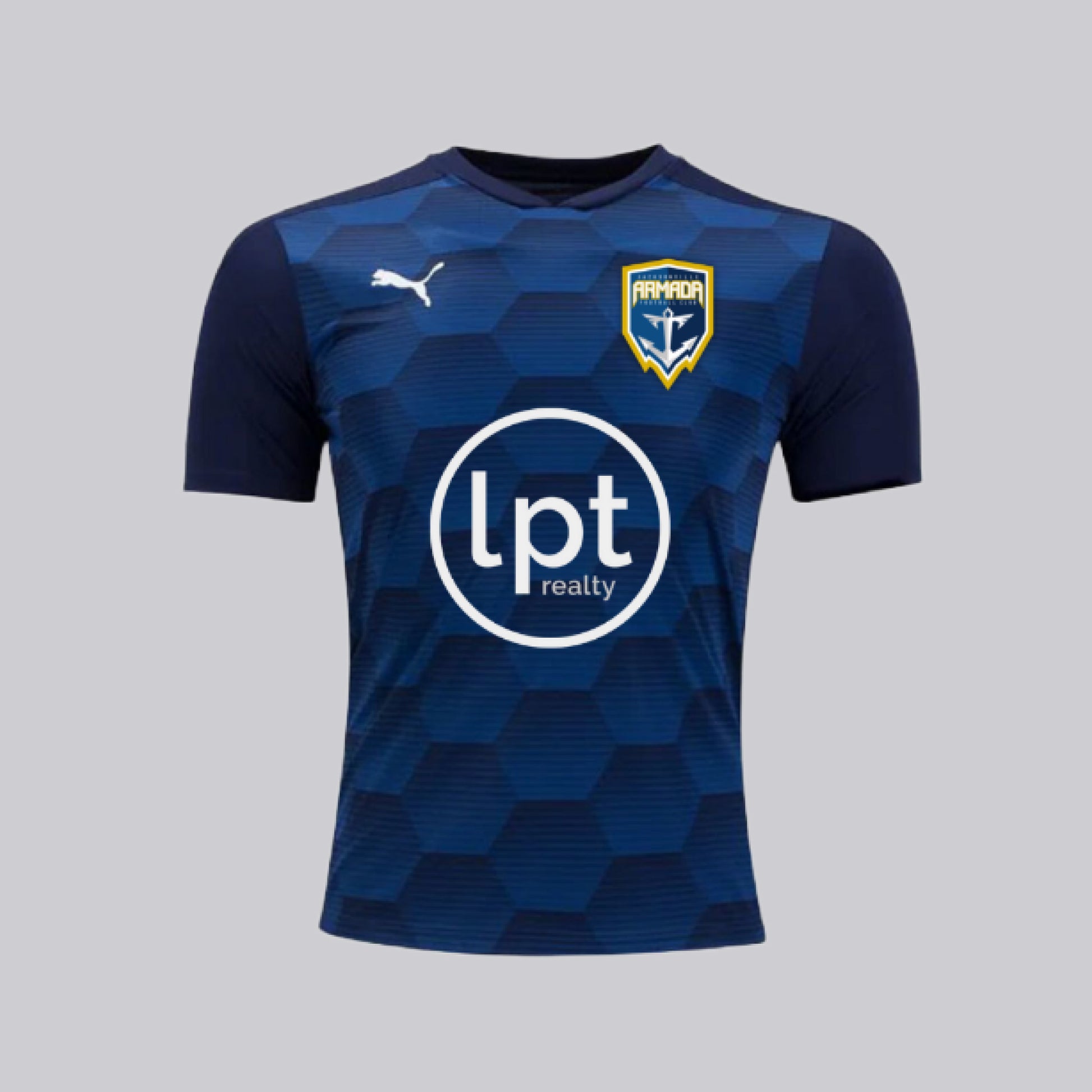 Navy blue slim-fit jersey with a honeycomb graphic pattern in gradient shades of blue on front panel. Features a slight v-neck, Armada’s signature crest logo on the upper left chest, PUMA’s white cat logo on the upper right, and LPT Realty’s circle logo prominently displayed in white in the mid-chest.  