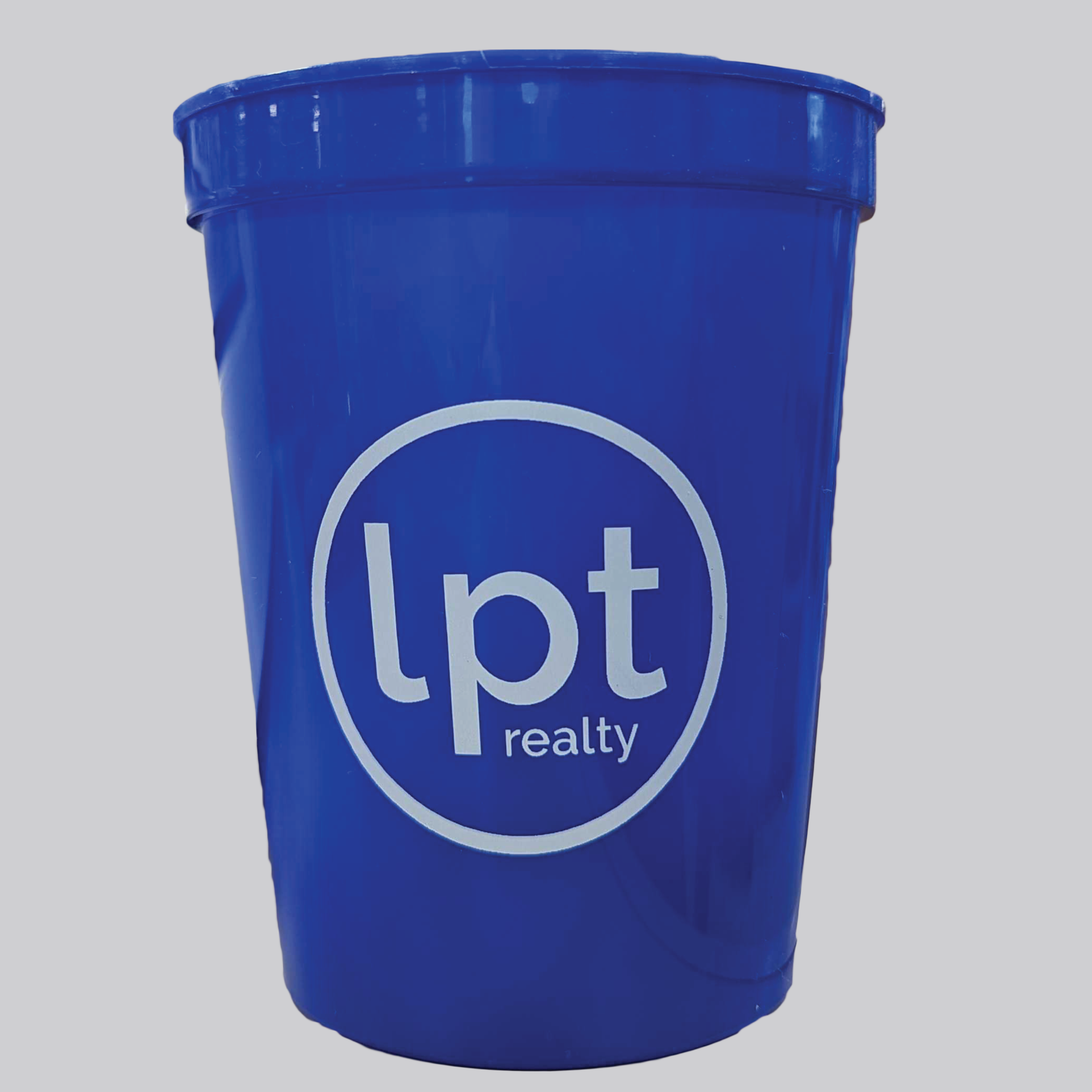 A royal blue, smooth-sided plastic tumbler prominently featuring LPT's circle logo in white. 