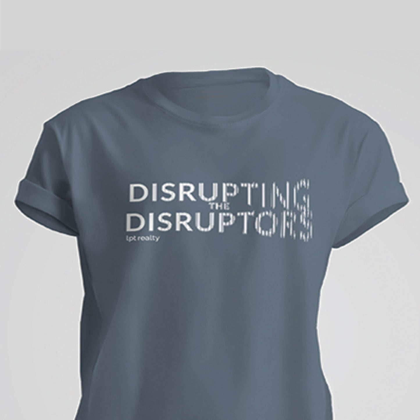 A steel blue, short-sleeved t-shirt featuring white text with the phrase “DISRUPTING THE DISRUPTORS” centered on the chest. The words "Disrupting” and “Disruptors” appear to disintegrate into a pixelated look toward the end, with the pixelation more pronounced on the final few letters. On the back, a few inches below the neckline, is the LPT circle logo. 