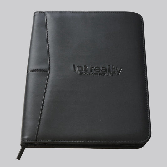 A black faux leather zippered portfolio with “lpt realty” embossed on the front center of the cover, and “BROKERAGE FOR LIFE ™” embossed just below it. Inside, the right side features a white, letter-sized lined notepad. The left side is a panel containing 8 business-card-sized pockets, a larger for a cell phone, and multiple accessory loops. This panel is the outer part of a larger gusseted pocket that can fit a notebook or tablet up to 10 inches.  